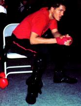 Jow Ga student rests on edge of chair after sparring.